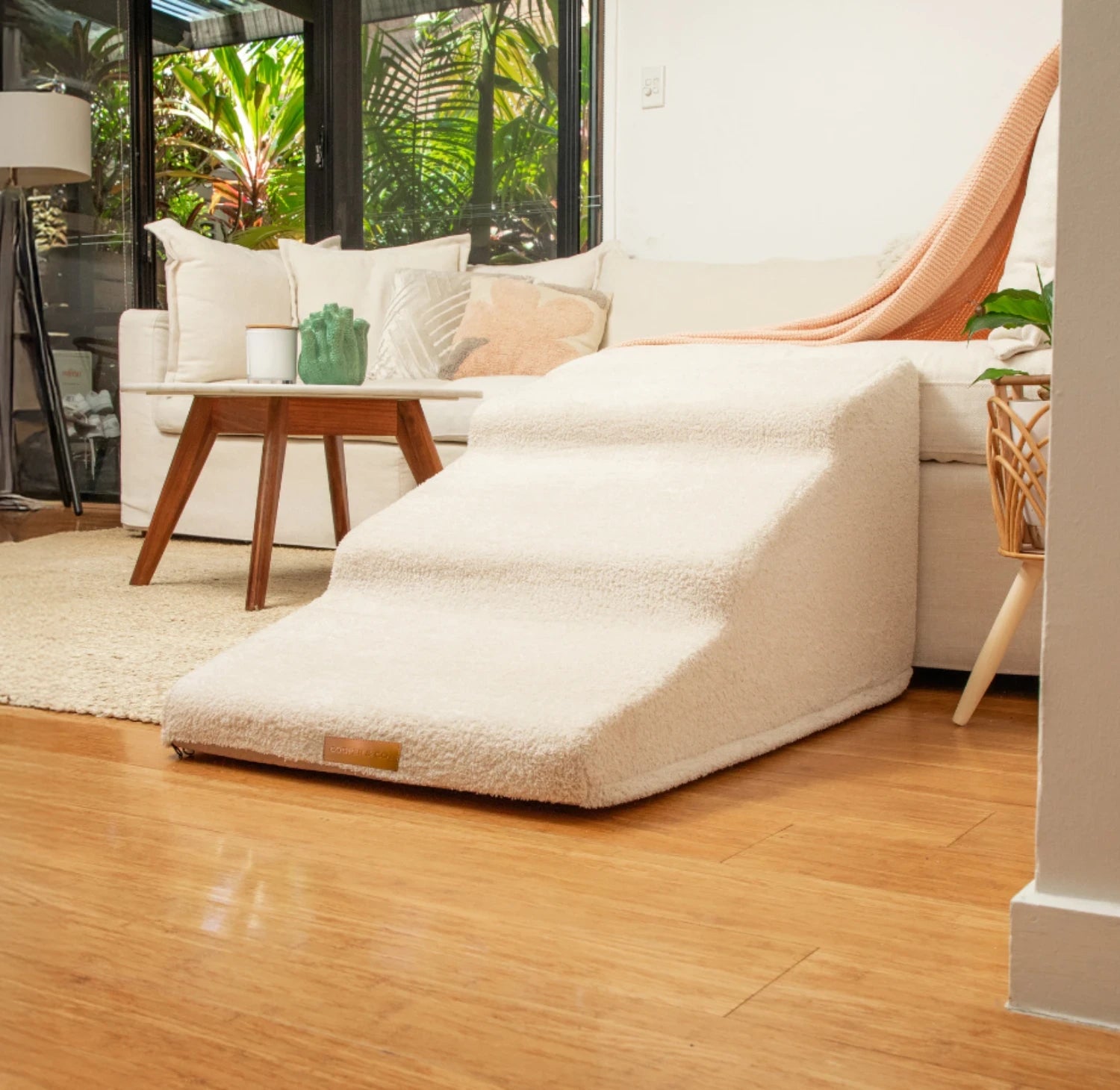 FlowSteps™ hybrid dog stairs in Sandy Beige fleece beside cream couch in modern Australian living room — Cooper & Co. Pets Australia